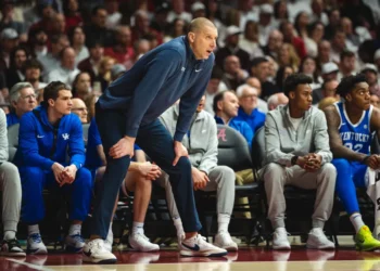 Referee stops game to stare at Mark Pope, who clearly was not happy with the officiating